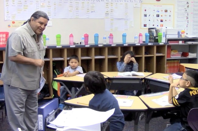 Man talking with kids in classroom. Man talking with kids in classroom.