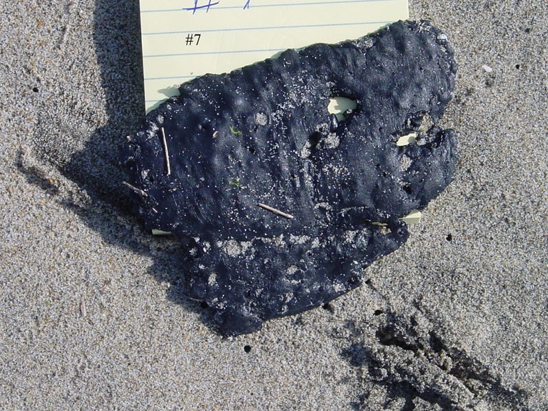 Black ball of tar on the beach.