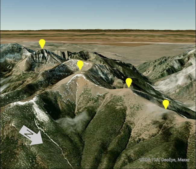 Four summits monitored using GLORIA methods at Great Sand Dunes National Park and Preserve Four yellow pins mark four summits in a mountain landscape.