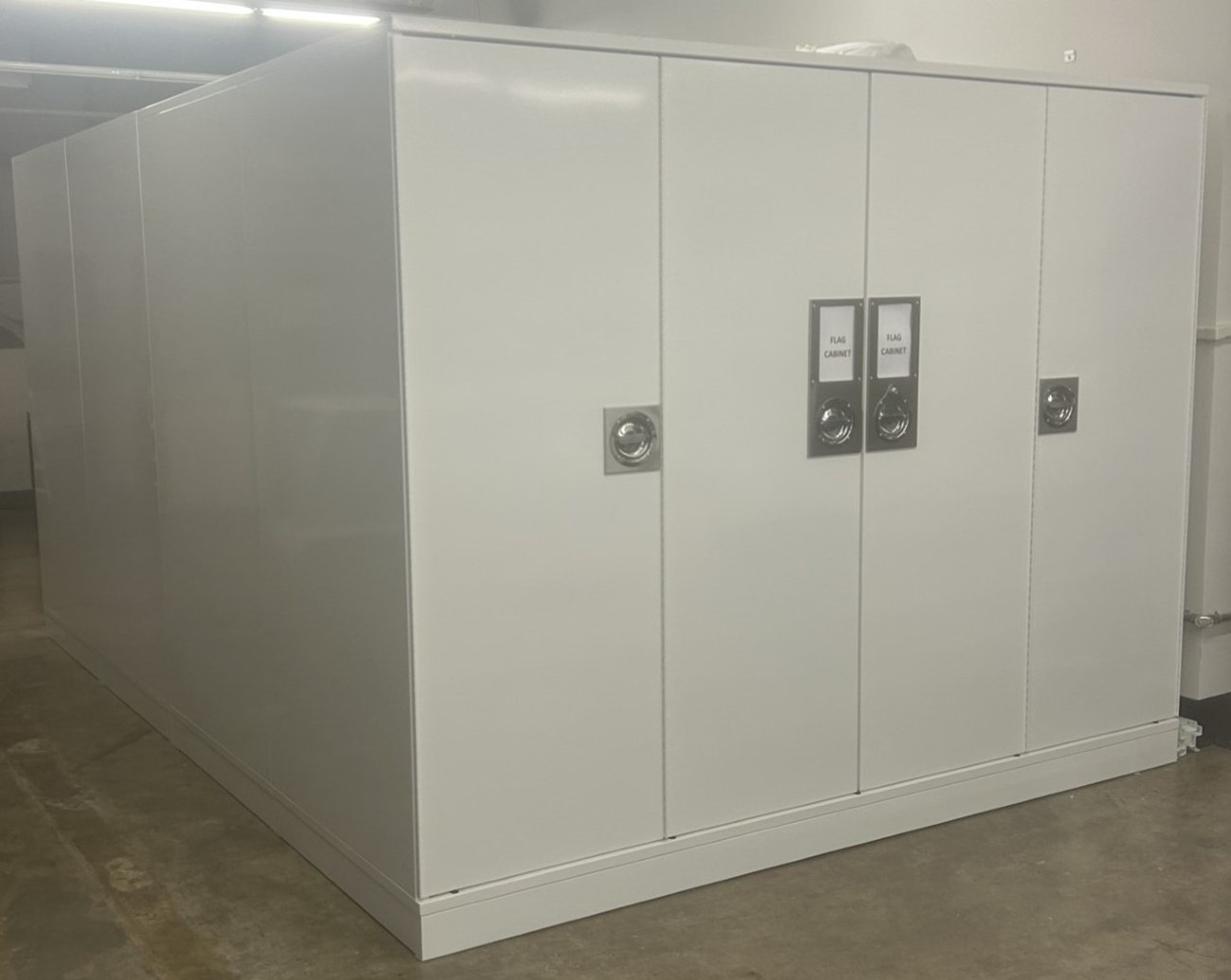 A very large white metal cabinet with two bi-fold doors.