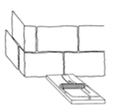 Line drawing of a mouse trap next to a wall.