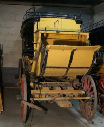 Stagecoach painted yellow with red painted spoke wheels. Stagecoach painted yellow with red painted spoke wheels.