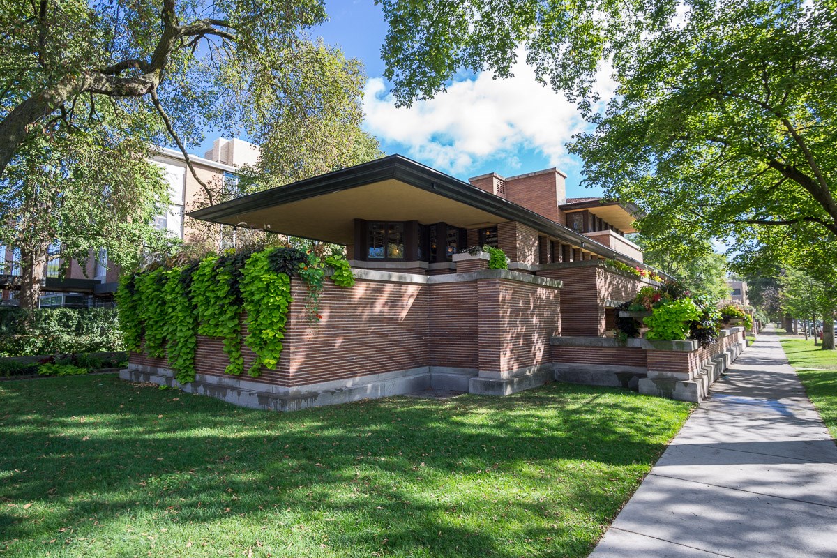 view of Frederick C. Robie House and lawn with neighboring sidewalk
