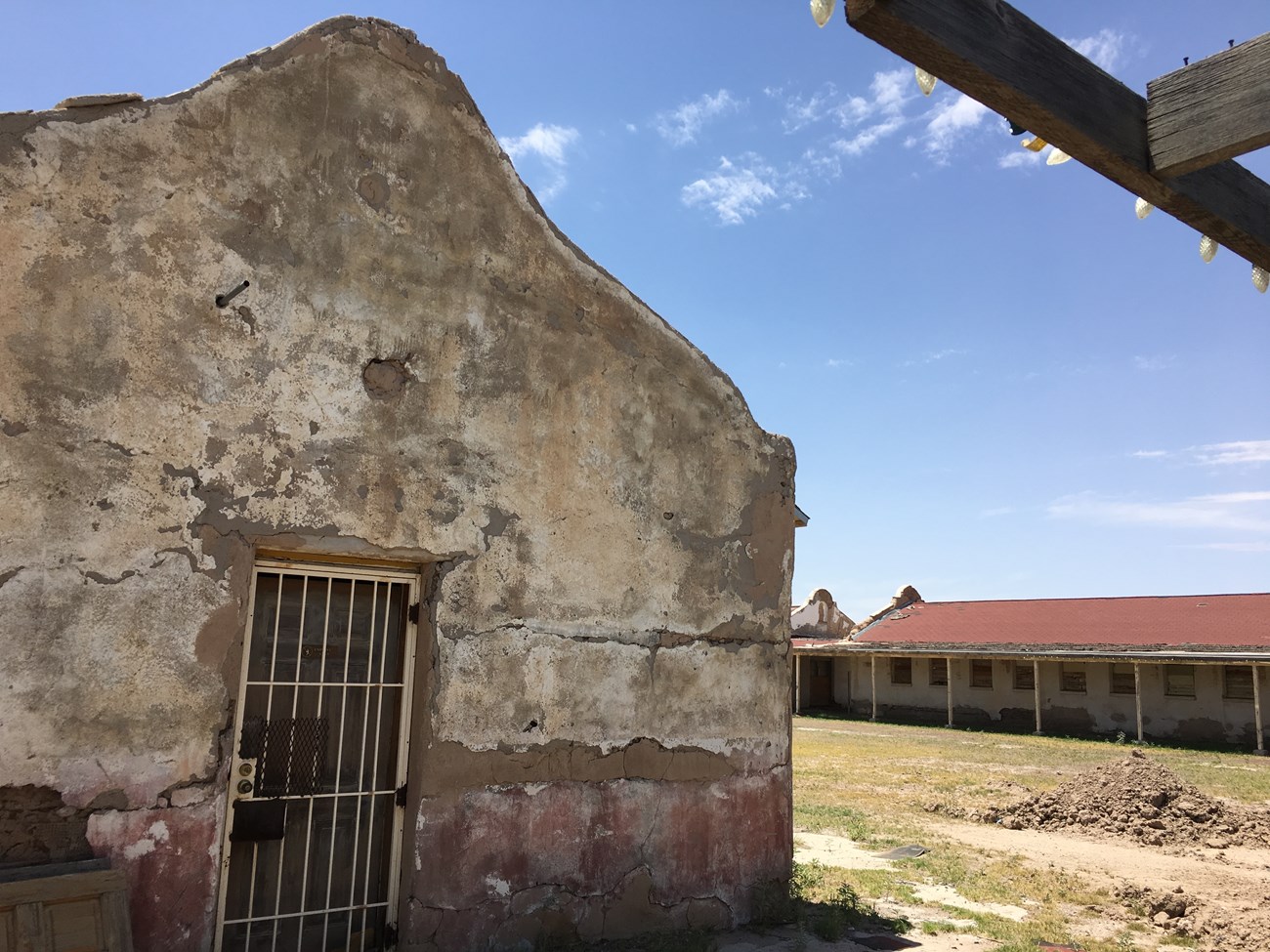 Entrance to one of the buildings at Rio Vista Bracero Reception Center with view of additional buildings across courtyard in background