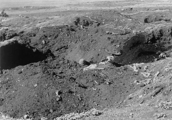 Mayughaaq site, 1985 with local digger amidst excavated holes