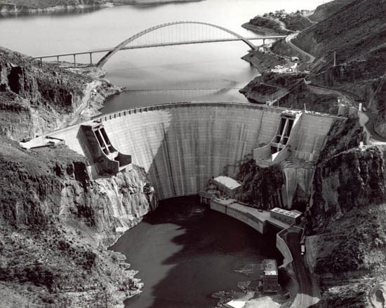 Aerial view of the reconstructed Roosevelt Dam with Roosevelt Lake Bridge in the background