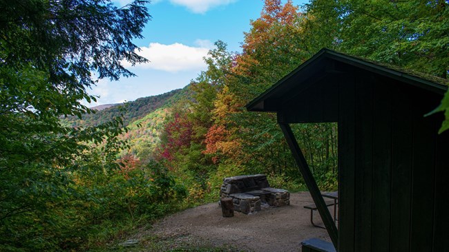 Coolidge State Park, Plymouth, Vermont Image of a mountain overlook. There is a small, wooden outpost to the right of the image.