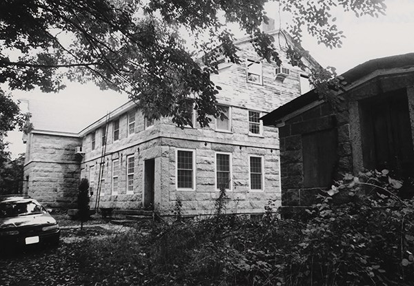 06000552 Upper Rockville Mill Image of stone building at top of grassy hill.
