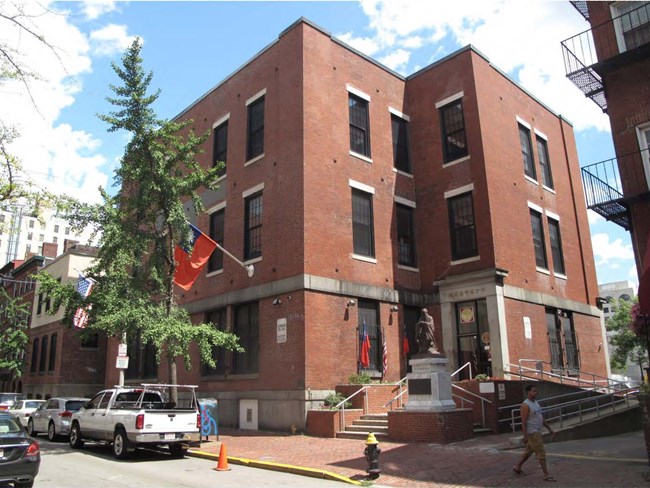 3 story brick building on corner of street