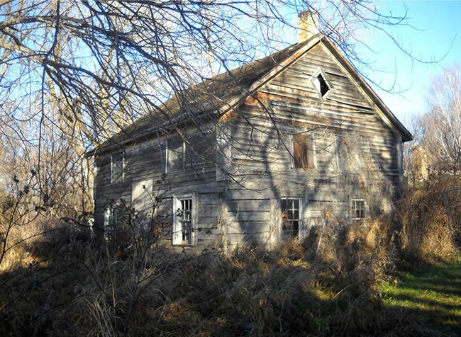 The two-story, gable-roofed log house