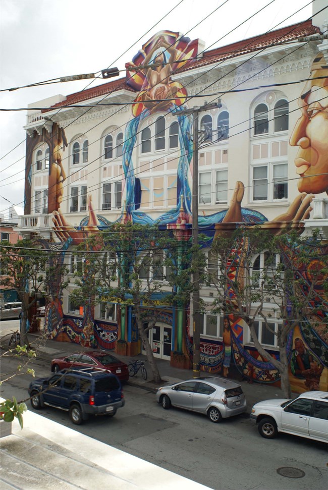 Building with murals and artwork on sides of building