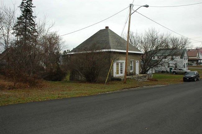 Former Town Office and Jail, single floor building sitting near the road.