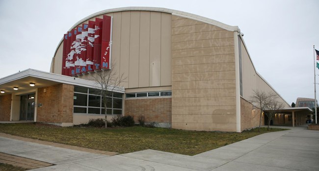 Gymnasium with barrel vault roof with a large banner on exterior