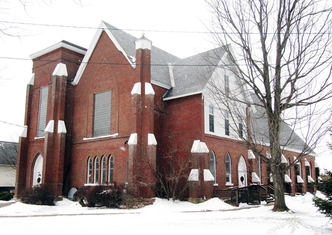 Brick church with large pointed arch window