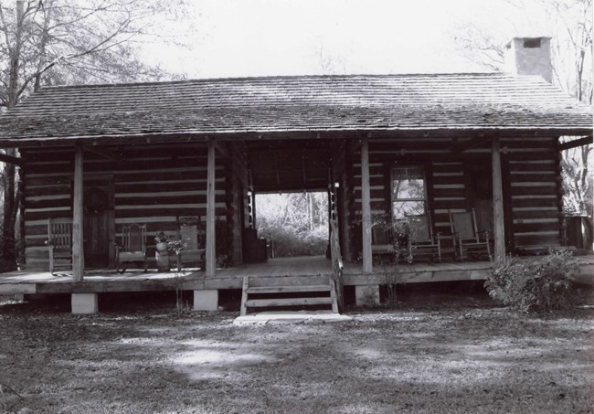 Rectangular house  that is a double pen dog-trot cabin with two end massive fireplaces