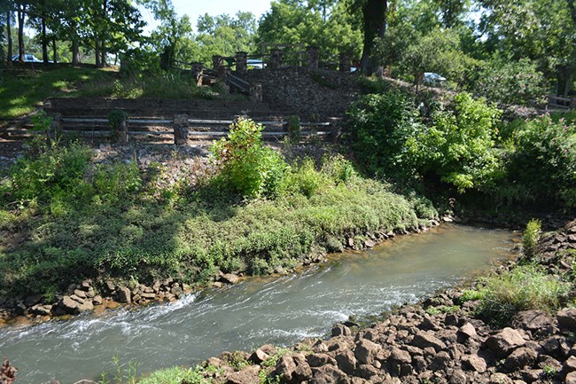 100011816 The Big Spring Image of water, plants, and stone structures.