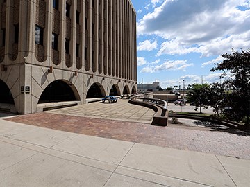 Image of building, sidewalk, and plazas.