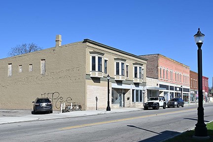A row of historic two-story brick buildings along a city street.