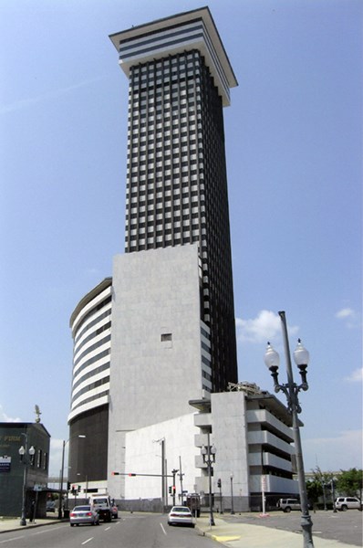 12001241 Plaza Tower Image of tall white and brown building, streets, sidewalks, and cars.