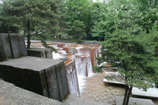 Water fountain in public area with block like waterfalls
