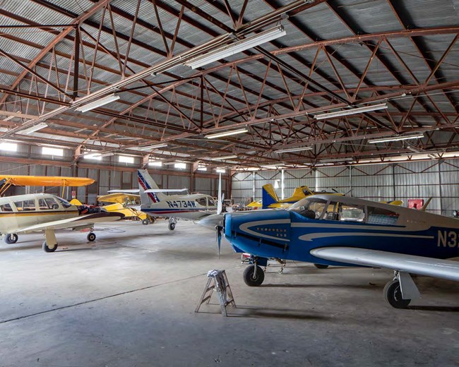 13000270_63rd Army Air Forces Contract Pilot School small airplanes in a hangar