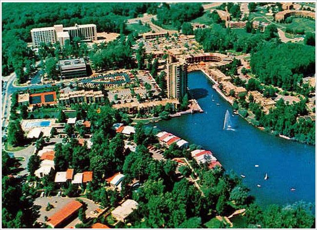 Lake Anne postcard reduced size Image of buildings, roads, parking lot, and lake.