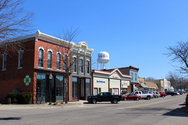 Row of historic brick buildings along a small town city street.