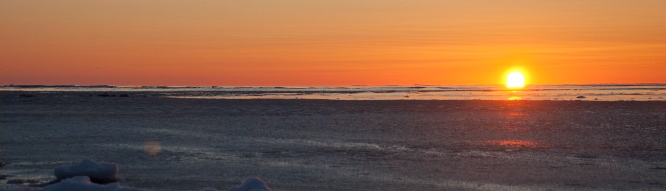 Low sunrise over a freezing ocean