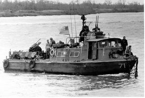 Swift Boat Black and white photo of a 50-foot patrol boat flying an American flag on the water.