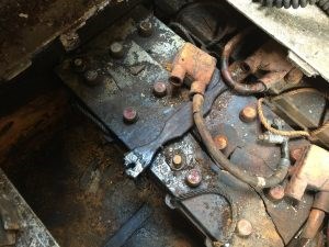 Deteriorated Batteries A corroded tank battery with rusted connectors sitting in a deteriorated compartment.