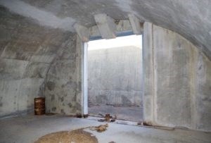 Ammunitions Magazine #129, Inside a cement room with a semi-circular wall and large entrance opening.