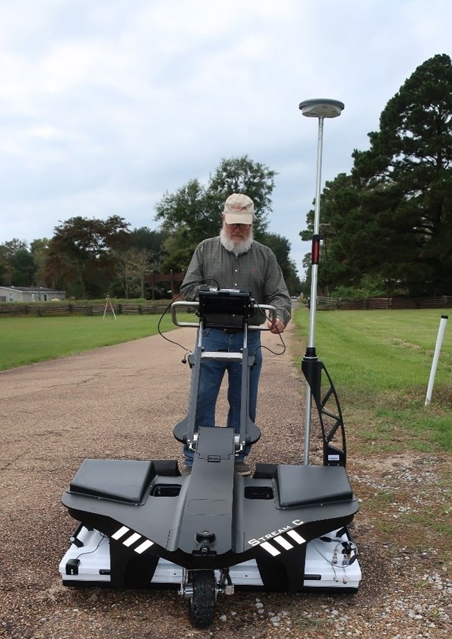Dan Elliot operating the “Stream C” compact array ground penetrating radar system. Dan Elliot operating the “Stream C” compact array ground penetrating radar system.