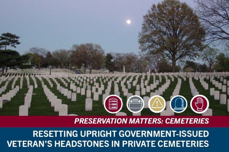 Rows of upright, white gravestones surrounded by green grass with the moon and trees in the background.