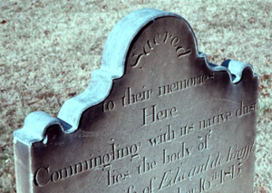 Historic copper cap over a stale grave marker.