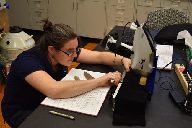 Catherine Cooper analyzes archaeological artifacts in the NCPTT labs.