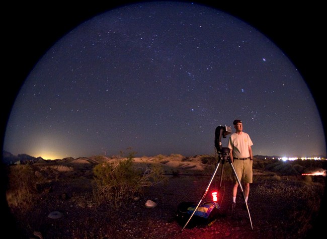 An NPS scientist in the field assesses natural and artificial sources of light