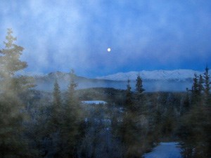 lt= Fog shrouds this view of a rising moon over Healy Ridge in Denali National Park and Preserve.