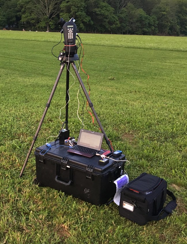 View of the CCD camera installed on a tripod in a grassy location.