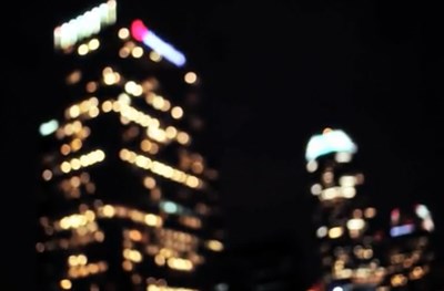 Disappearing Darkness II Slightly out of focus lit skyscraper buildings at night