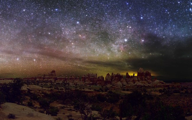 A tapestry of stars illumine night sky above Dollhouse, Canyonlands National Park