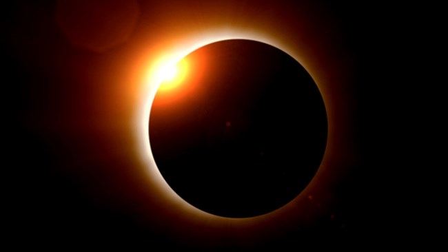 Total solar eclipse shows sun's corona from behind the moon.