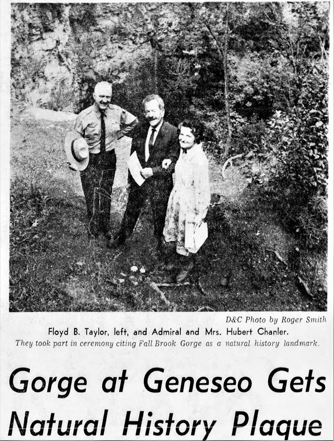 newspaper article depicting people and plaque