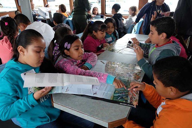 students reading materials on a table
