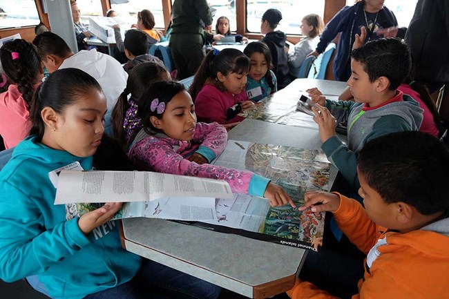 Students students reading materials on a table