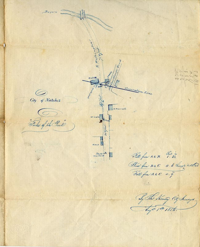 Hand drawn map shows structures and roads, with descriptive writing around the edges.