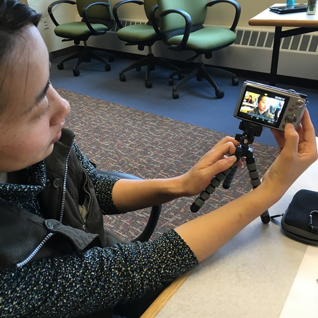 A student shows the framing on camera of her practice video interview.
