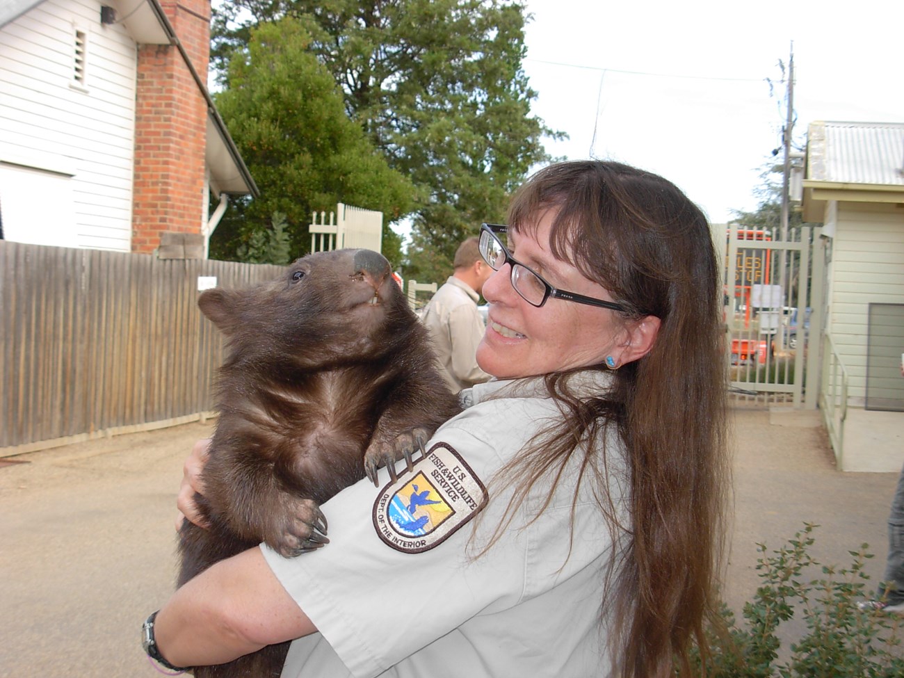 Mary Kwart cradles a wombat over her shoulder