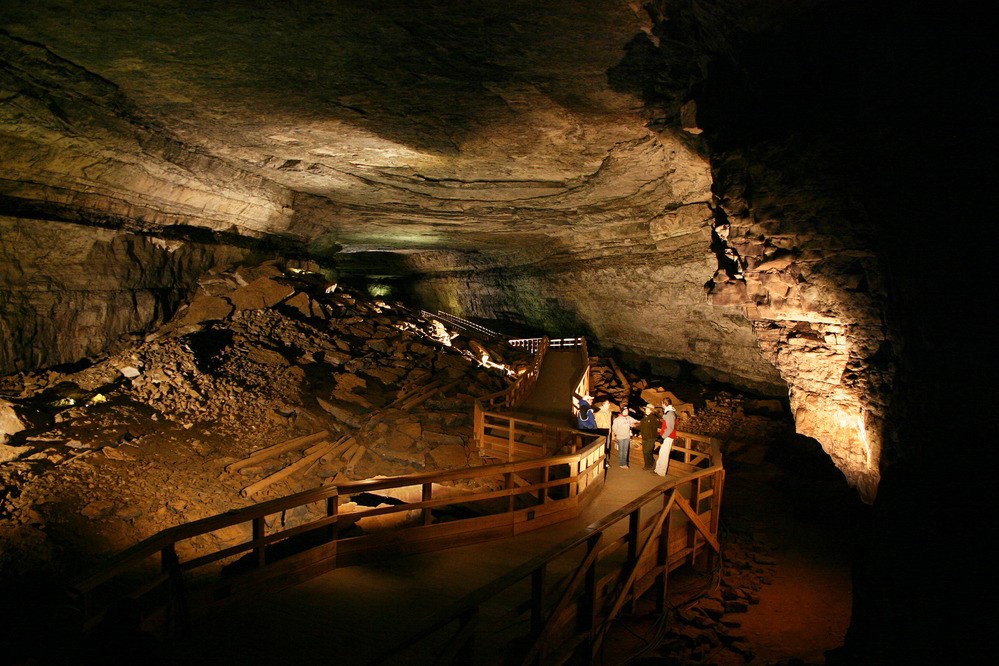 A park ranger describes Mammoth Cave to visitors in the expanse of Broadway, one of the cave's vast canyon passages.