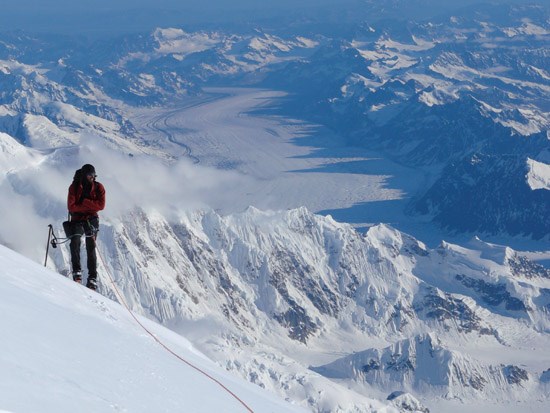 Mountaineer with climbing gear on a snowy mountain at Denali