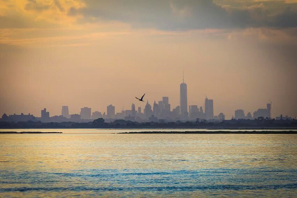 New York City skyline over the water at sunset